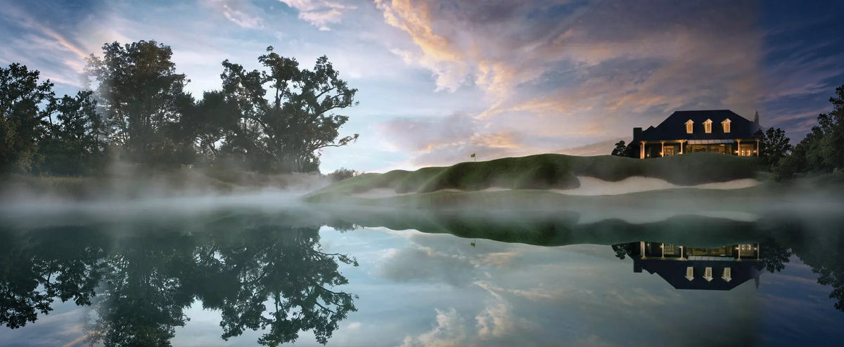 The clubhouse and a green at Fallen Oak in Saucier, Mississippi, reflected in still water at dawn.